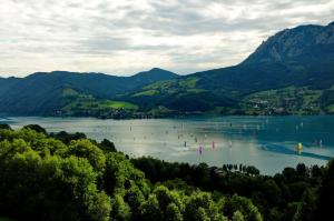 a group of people on a lake in the mountains at Ferienhof Margarethengut in Unterach am Attersee