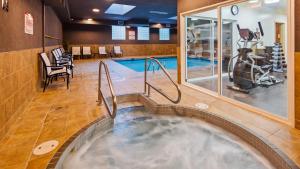 a hot tub in a gym with a swimming pool at Best Western King George Inn & Suites in Surrey