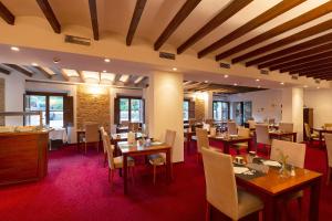 a dining room with wooden tables and chairs at Gran Hotel Soller in Sóller