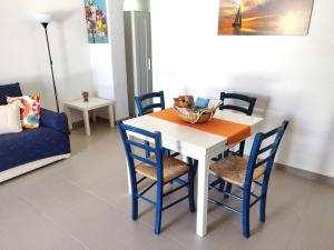 a dining room with a table and chairs at La Casa dei Girasoli in Marzamemi