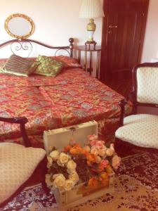 a bedroom with a bed with a box of flowers on the floor at Magnolia House in Taurianova