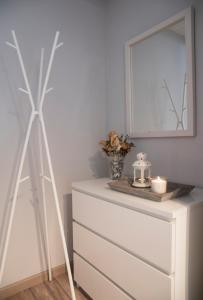 a dresser with a mirror and a dresser with a windmill at Apartamento Jaca Snow in Jaca +2 photos
