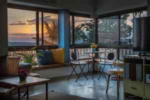 a living room with a view of the ocean at Desert Picture in Arad