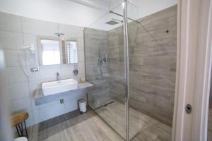 a bathroom with a sink and a glass shower at La seconda Luna in Pollutri