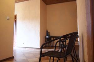 a chair sitting in a room with a table at Pokoje u Wojtka Charbrowo in Charbrowo