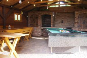 a patio with a pool table and a dining area at Pokoje u Wojtka Charbrowo in Charbrowo