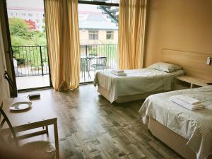 Postel nebo postele na pokoji v ubytování Hotel Amigo II