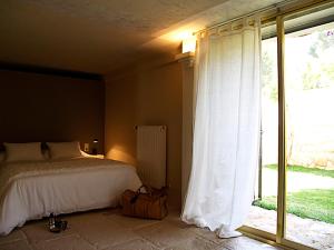 a bedroom with a bed and a large window at Villa Relax en Benidorm in Benidorm