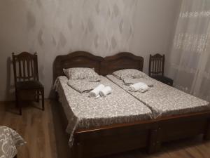 a bedroom with a bed with two stuffed animals on it at agmashenebeli95 in Tbilisi City +33 photos
