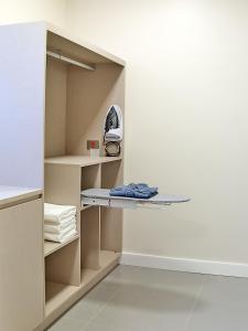 a closet with a shelf and a iron at Rio Hotel By Bourbon Campinas in Campinas