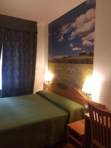 a hotel room with two beds and a painting on the wall at B&B Le Stagioni in Potenza