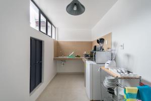 a small kitchen with a sink and a refrigerator at JUUB @ THE SOUL OF OAXACA (R3) in Oaxaca City