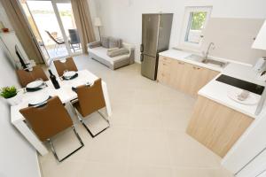 a kitchen with a table and chairs and a sink at Apartments Piazza in Nin +37 photos