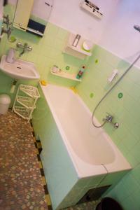 a bathroom with a tub and a sink at Apartmán Štrba in Štrba