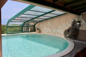 a large swimming pool in a building with a large window at Villa Meri in Rijeka