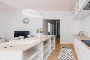 a kitchen with a large counter with white cabinets at Wiigi Apartments in Haapsalu
