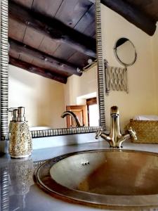 a bathroom with a sink and a mirror at Al Agia - Mirador de los Quinientos in Padul