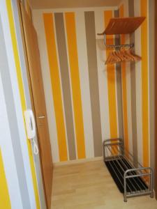 皮爾納的住宿－Ferienwohnung Angelo，一条拥有黄色和白色条纹墙的走廊