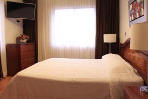 A bed or beds in a room at Miraflores Pacific Hotel