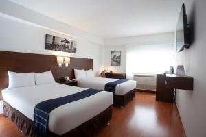 Un pat sau paturi într-o cameră la Casa Andina Select Miraflores