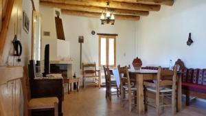 a dining room with a table and chairs at ARADENA TRADITIONAL House 1 in Arádhaina