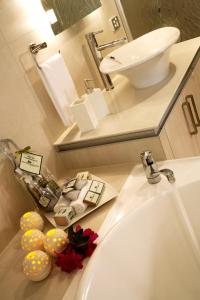 a white bathroom with a sink and a mirror at Heritage Trail Lodge in Margaret River Town