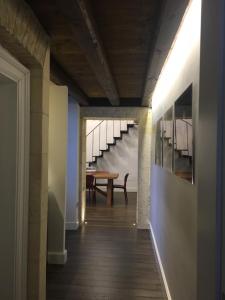 a hallway with a table and stairs in a building at Arcipelago 37 in Cagliari