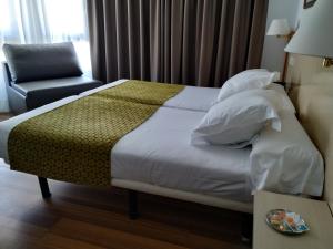 Postel nebo postele na pokoji v ubytování Hotel Ezeiza