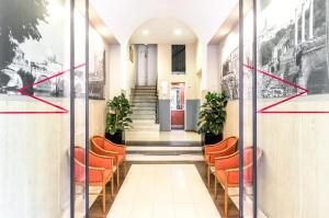 a hallway with orange chairs in a building at La dolce vita QG in Rome