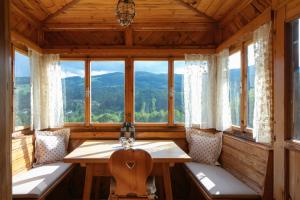 a room with a table and windows in a cabin at Haus Annerl in Stainz