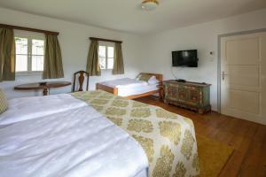 a bedroom with a bed and a tv and a table at Haus Annerl in Stainz