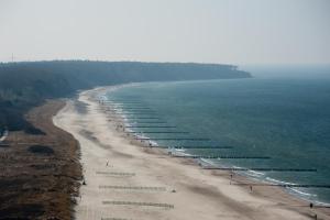 an aerial view of a beach with a row of boats at Strand-Hotel Hübner in Warnemünde