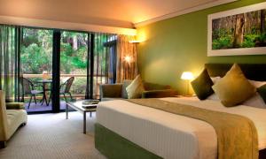a hotel room with a bed and a living room at Heritage Trail Lodge in Margaret River Town