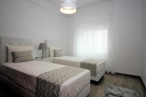 A bed or beds in a room at Apartamentos Gaivota Holidays