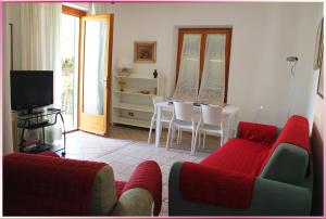 a living room with a couch and a table with chairs at Il Giardino Segreto (Villa Cristina) in Lerici