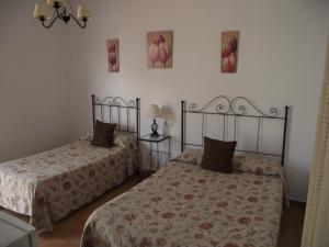 Postel nebo postele na pokoji v ubytování Hostal El Canario