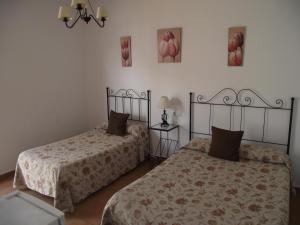 Postel nebo postele na pokoji v ubytování Hostal El Canario