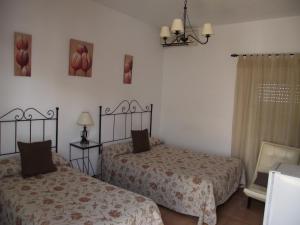 Postel nebo postele na pokoji v ubytování Hostal El Canario