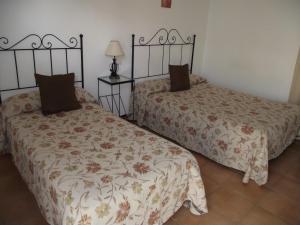 Postel nebo postele na pokoji v ubytování Hostal El Canario