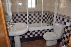 a bathroom with a sink and a toilet and a tub at Villa Canela with Heated Pool, Piscina Climatizada in Isla Canela +12 photos