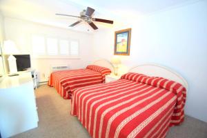 a hotel room with two beds and a ceiling fan at Breakaway East 109 in Ocean City