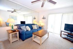 a living room with a blue couch and a table at Breakaway East 109 in Ocean City