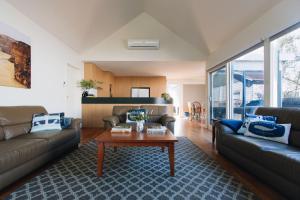 a living room with two couches and a coffee table at Torquay Retreats Aus - Eighteen Beach in Torquay