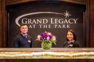 a man and woman standing behind a counter with flowers at Grand Legacy At The Park in Anaheim +37 photos