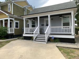 a house with a front porch with white railings at Peaceful Getaway for Two in Lincolnville/Quiet Area/2.3 Miles to Beach in Saint Augustine