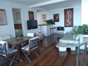 a living room with a table and a couch at Apartamento Ipanema in Rio de Janeiro