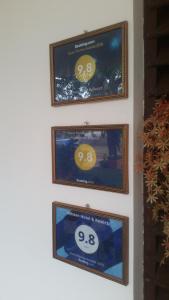 three framed pictures on a wall with smiles on them at Miheen Hotel & Resort - Anuradhapura in Mihintale