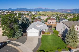 an aerial view of a house with a driveway at Cozy 4BR House with Peak Views in Colorado Springs in Colorado Springs