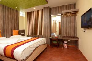 A bed or beds in a room at Maya Boutique Hotel 