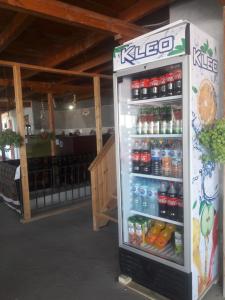 a refrigerator filled with bottles of soda in a store at Hotel Botanical in Samarkand